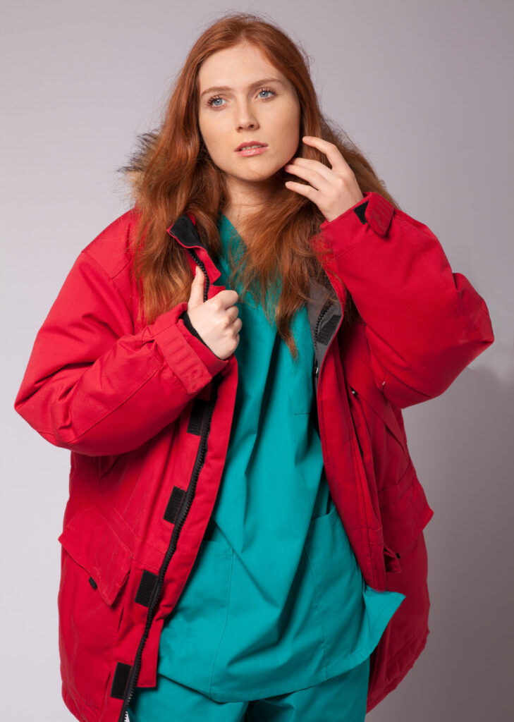 Cover image for a romance novel. A female surgeon dressed in scrubs and a winter coat.